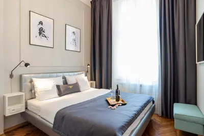 a bedroom with a bed with a blue blanket at Bentis Luxury Apartments in Kraków