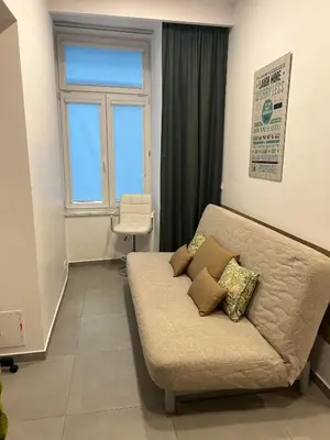 a living room with a couch and a window at Apartament Starowiślna in Kraków
