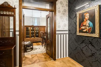 a hallway of a home with a painting on the wall at Exclusive Royal Apartments in Kraków