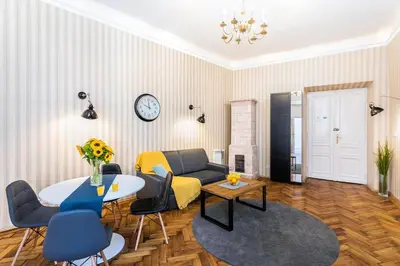 a living room with a couch and a table at Exclusive Royal Apartments in Kraków