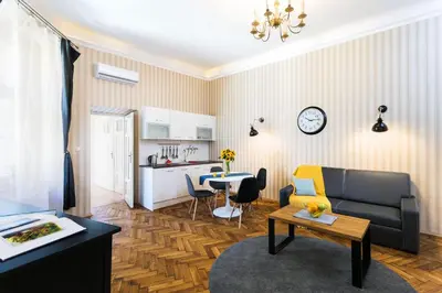 a living room with a couch and a table at Exclusive Royal Apartments in Kraków