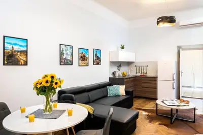 a living room with a couch and a table at Exclusive Royal Apartments in Kraków