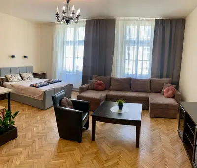 a living room with a couch and a bed at Apartamenty i Studia HERBARIUM in Kraków