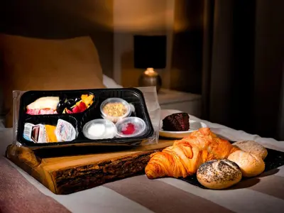 a tray of food sitting on a table with bread at Apartamenty i Studia HERBARIUM in Kraków