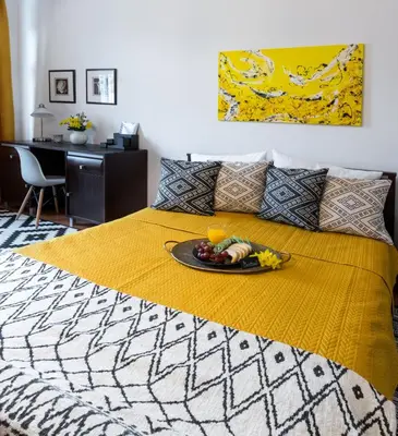 a bed with a plate of fruit on it at Cichy apartament obok Wawelu Tarłowska in Kraków