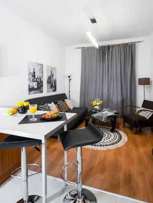 a living room with a table and a couch at Cichy apartament obok Wawelu Tarłowska in Kraków