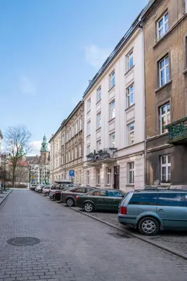a row of cars parked in front of buildings at Cichy apartament obok Wawelu Tarłowska in Kraków