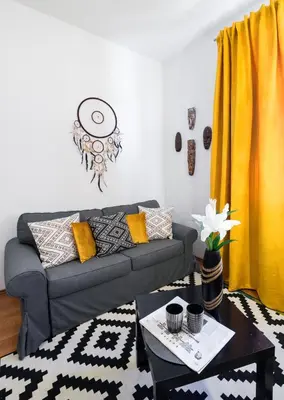 a living room with a couch and a table at Cichy apartament obok Wawelu Tarłowska in Kraków