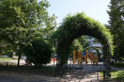 an arch in a park with a playground at Spacious Apt by Airport Train Old Town in Kraków