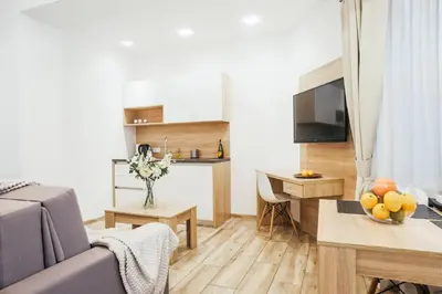 a living room with a couch and a table at Way2Stay Bosacka in Kraków
