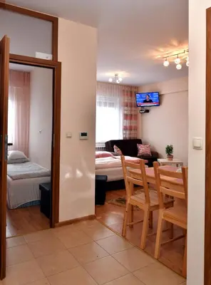 a living room with a table and a dining room at Zator Apartamenty Weekend in Zator