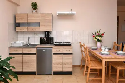 a kitchen and dining room with a table and chairs at Zator Apartamenty Weekend in Zator