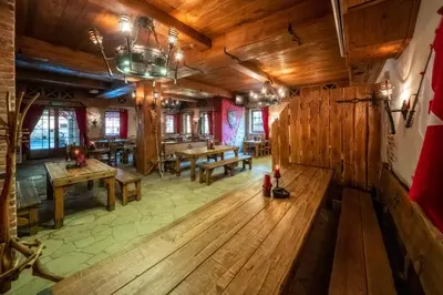 an overhead view of a restaurant with wooden floors and tables at Pokoje w Oberży Czarny Groń in Rzyki