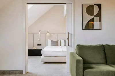 a lobby with a stone wall and a fireplace at Poziom 511 Jura Wellness Hotel & Spa in Ogrodzieniec