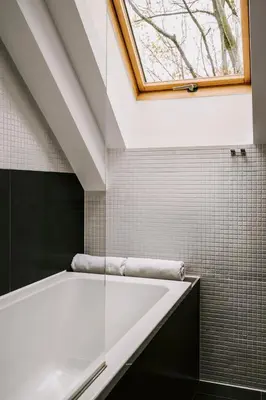 a bathroom with a window and a bath tub at Poziom 511 Jura Wellness Hotel & Spa in Ogrodzieniec