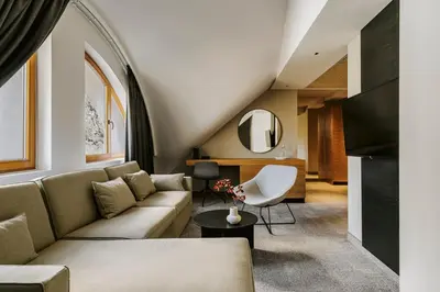 a living room with a couch and a table at Poziom 511 Jura Wellness Hotel & Spa in Ogrodzieniec