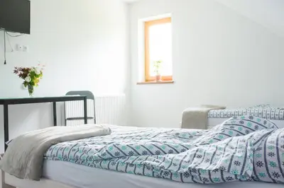 a bedroom with two beds and a table at Staś -przy szkole nr 3 w Skawie in Skawa