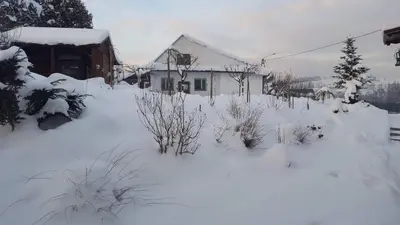 a yard covered in snow in front of a house at Staś -przy szkole nr 3 w Skawie in Skawa