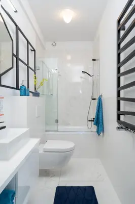 a white bathroom with a shower and a toilet at 3 Minutes Apartments Old Town in Kraków