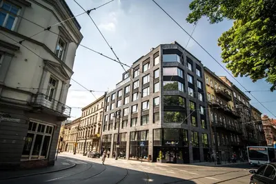 a tall building on a city street at 3 Minutes Apartments Old Town in Kraków