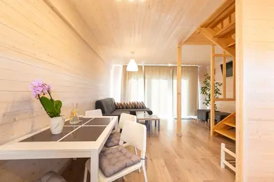 a living room with a table and a couch at Old Tree Village & Restaurant in Oświęcim