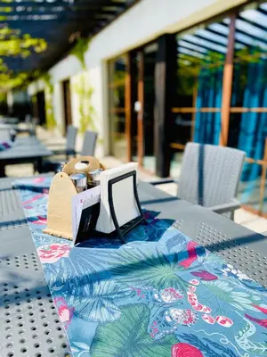 a table with a table cloth with a laptop on it at Old Tree Village & Restaurant in Oświęcim