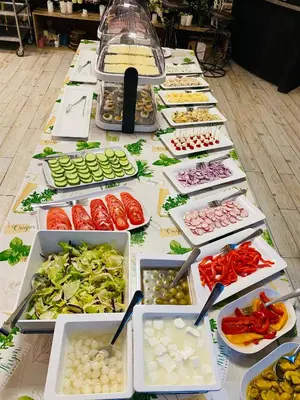 a long table filled with different types of vegetables at Old Tree Village & Restaurant in Oświęcim