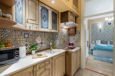a kitchen with wooden cabinets and a sink at Anno Domini Apartment by Cozyplace in Kraków