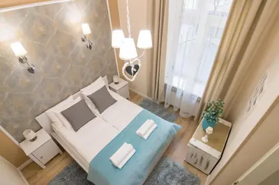 a small bedroom with a bed and a window at Anno Domini Apartment by Cozyplace in Kraków