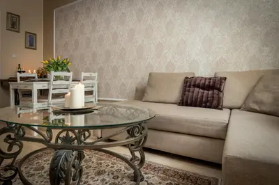 a living room with a couch and a table with a candle at Anno Domini Apartment by Cozyplace in Kraków