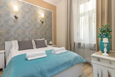 a bedroom with a bed with two pillows on it at Anno Domini Apartment by Cozyplace in Kraków