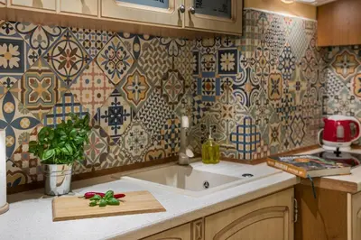 a kitchen with a sink and a tile wall at Anno Domini Apartment by Cozyplace in Kraków