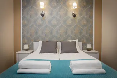 a bedroom with a large bed with two pillows at Anno Domini Apartment by Cozyplace in Kraków