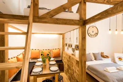 a room with two bunk beds and a table at Cracow Best Location Apartment by Cozyplace in Kraków