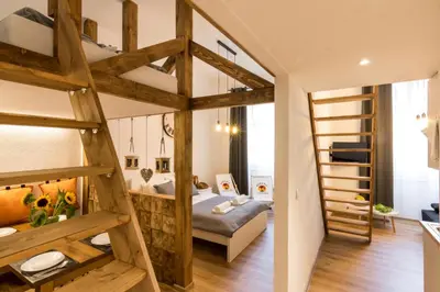 a large room with a bunk bed and a ladder at Cracow Best Location Apartment by Cozyplace in Kraków