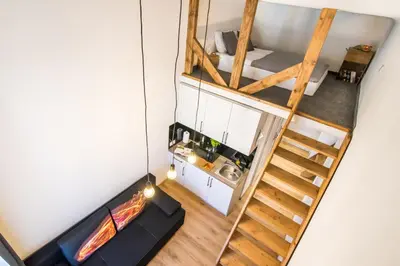 an overhead view of a room with a spiral staircase at Cracow Best Location Apartment by Cozyplace in Kraków