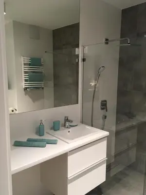 a bathroom with a white sink and a shower at Apartment in the Gantry Hall - W19 in Kraków