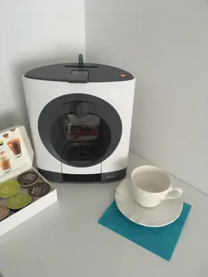 a microwave with a cup and a plate on a counter at Apartment in the Gantry Hall - W19 in Kraków