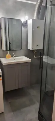 a bathroom with a sink and a mirror at Apartament Kolorowy in Kraków