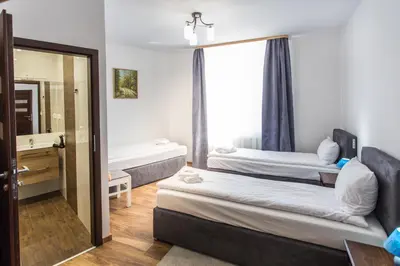 a room with two beds and a mirror at Fogra Travel Apartment in Kraków