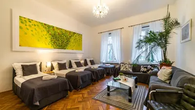 a living room with couches and a painting on the wall at Fogra Travel Apartment in Kraków
