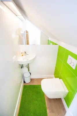 a bathroom with a white toilet and a sink at Apartamenty SaltApart2 in Wieliczka