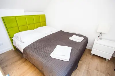 a bedroom with a bed with two towels on it at Apartamenty SaltApart2 in Wieliczka