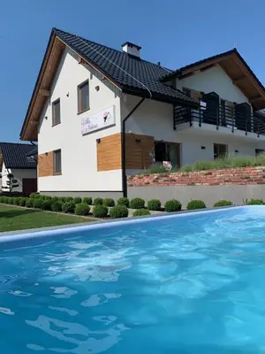 a house with a swimming pool in front of it at Villa Natura Zator Przeciszów in Zator