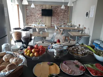 a table topped with lots of different types of food at Villa Natura Zator Przeciszów in Zator