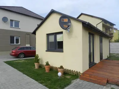 a house with a parking meter on the side of it at Dobranocka - pokoje i całoroczne domki blisko Energylandii in Zator