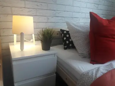 a bedroom with a bed with a lamp and pillows at Dobranocka - pokoje i całoroczne domki blisko Energylandii in Zator