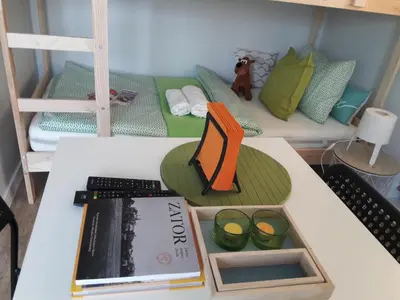 a toy room with a table with a book and a bed at Dobranocka - pokoje i całoroczne domki blisko Energylandii in Zator