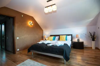 a bedroom with a bed with towels on it at Charming place - Kraków Gdów Jacuzzi in Gdów