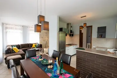 a kitchen and living room with a table and chairs at Charming place - Kraków Gdów Jacuzzi in Gdów